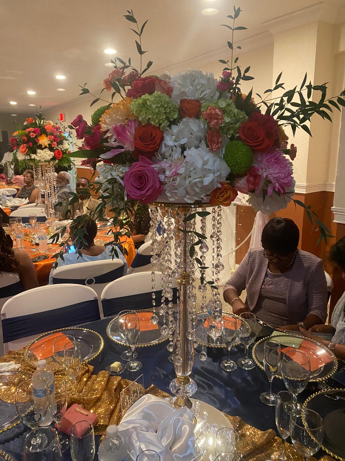 Banquet hall event space with draped curtains and table settings.