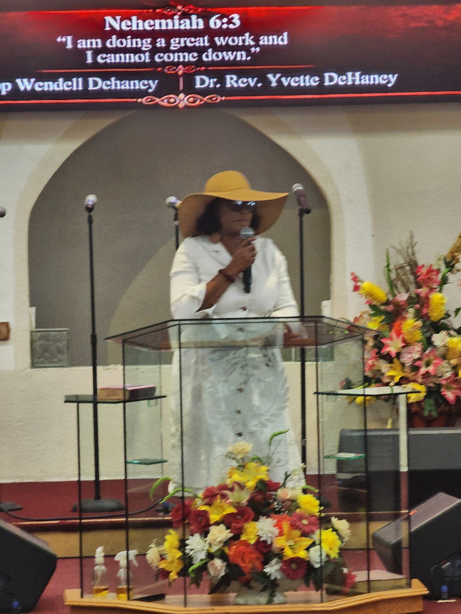Rev. Dr. Yvette DeHaney speaking at the Ingathering service podium.