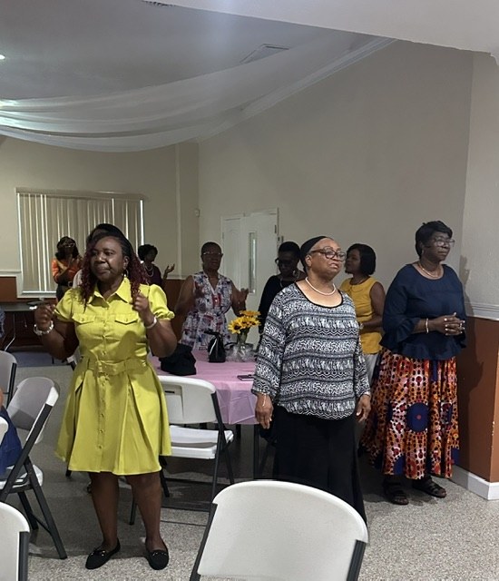 Women worshiping together at the Know Your Neighbor Prayer Breakfast.